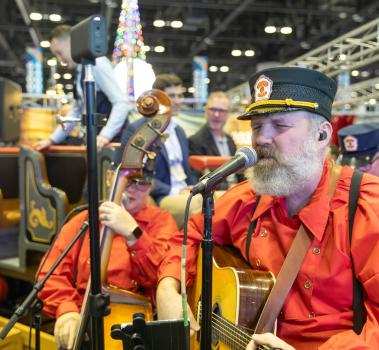 Casey and The Atta Boys performing from Silver Dollar City and Rocky Mountain Construction booth at IAAPA Expo 2023