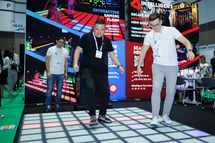 Two men looking at a dance floor on the trade show floor