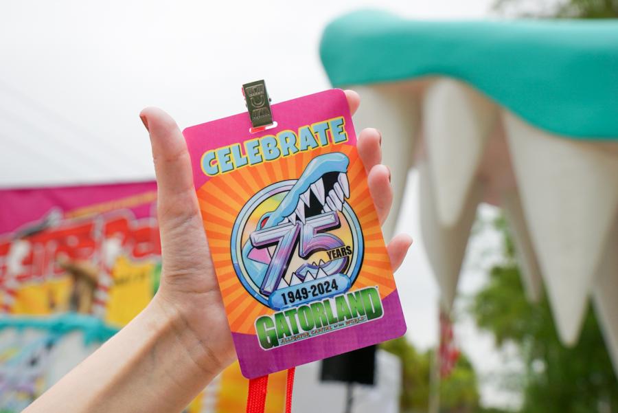 Gatorland media lanyard held up in front of the entrance to the park.