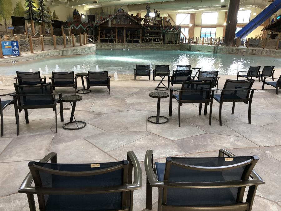 Spaced out chairs beside an indoor pool
