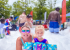 Mom and Daughter at water park playing in a pile of foam-like substance.