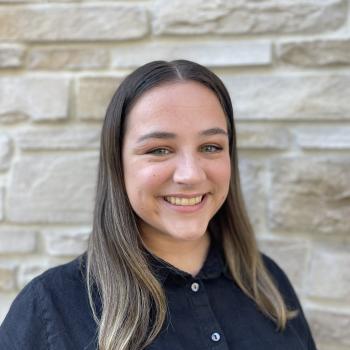 Female smiling against brick background