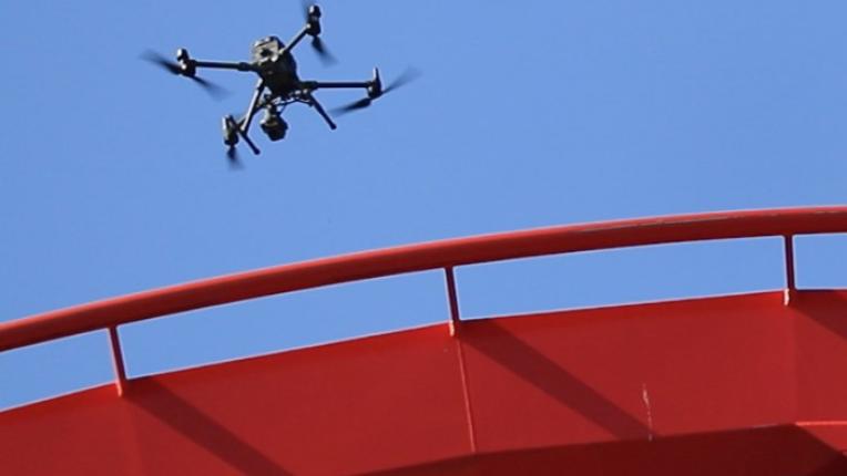 A drone performs an inspection of roller coaster track at Carowinds amusement park