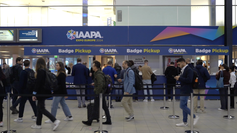 People wearing dark clothing stand in line to grab their entry badge at IAAPA Expo Europe in Amsterdam