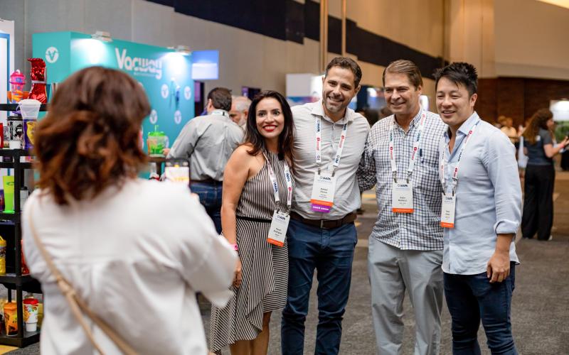 IAAPA Latin America Summit attendees pose for a photo while shopping for new products and services